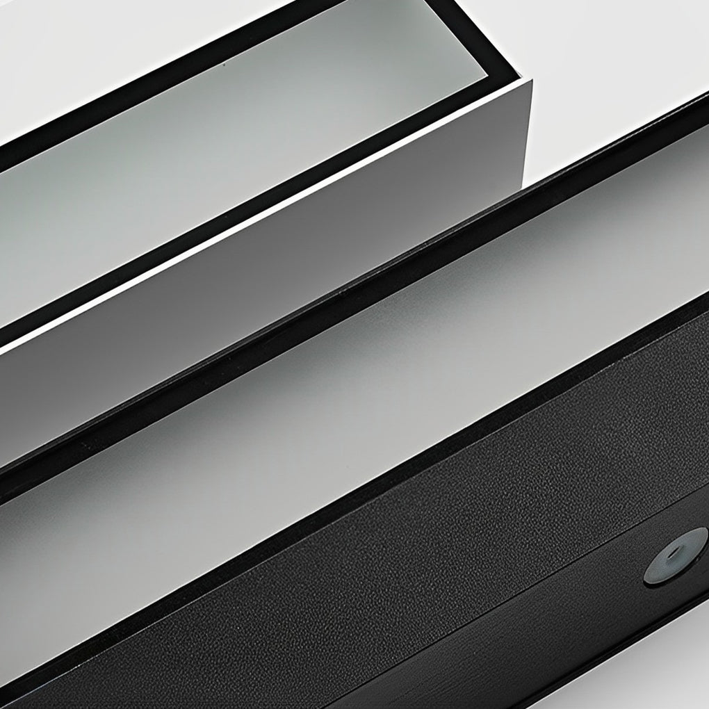 Close up detail of exterior porch light fixtures showing slim metal housing and LED diffuser.