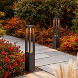 LED bollard garden light with sleek rectangular design, installed along garden pathway for warm and modern illumination